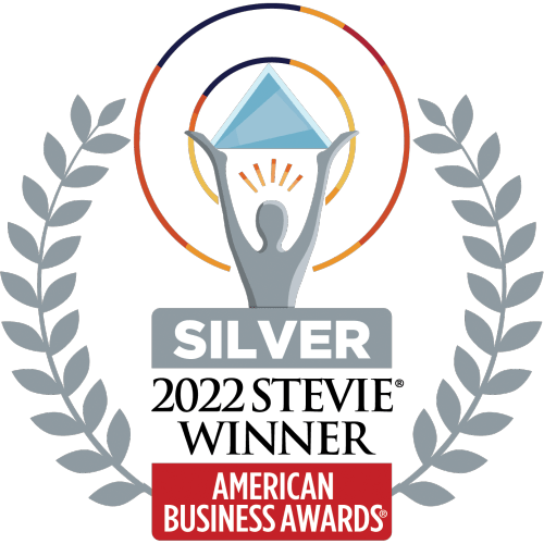 Silver Stevie Winner badge for the 2022 American Business Awards, featuring a figure holding a star within a silver laurel wreath, and a circular orange and blue gradient background