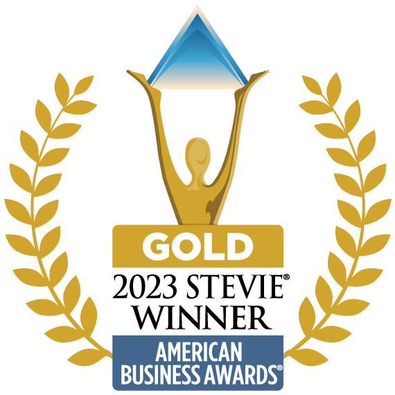 Gold Stevie Winner badge for the 2023 American Business Awards, featuring a figure holding a star within a gold laurel wreath, against a blue triangle and green background.