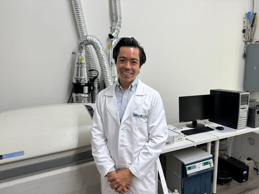 Photo — in-house QC lab, a technician verifying potency and purity.