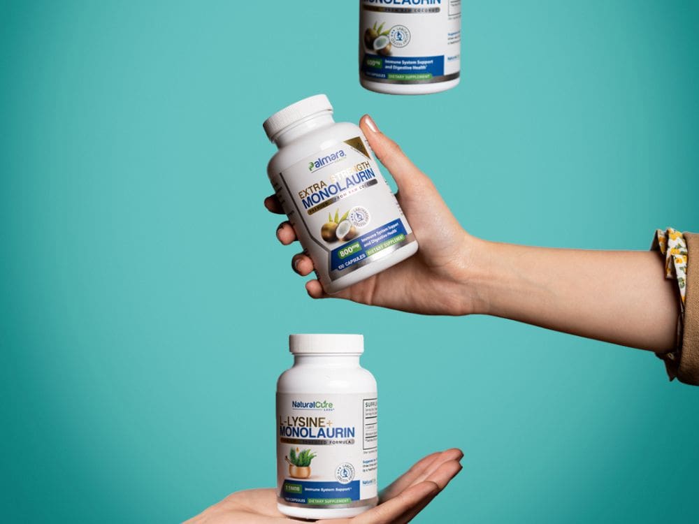 Hands holding NCL Extra Strength Monolaurin and L-Lysine with Monolaurin